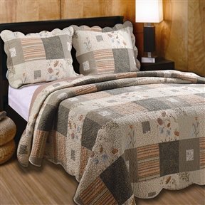 A well-arranged bed showcasing a vibrant quilt and an assortment of soft pillows, creating a warm atmosphere.