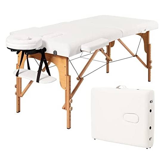 A pristine white massage table with a matching cover, designed for comfort and relaxation in a therapeutic setting.