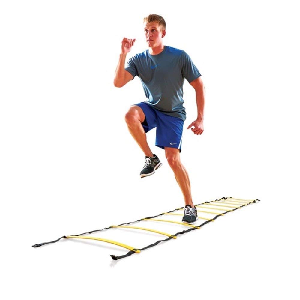 A man runs on a ladder against a plain white background, showcasing agility and balance in an unusual setting.