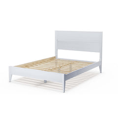 A white bed featuring wooden slats and a wooden headboard, showcasing a modern and minimalist design.