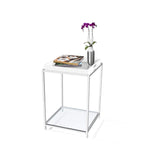 A white side table with a flower vase placed on top, adding a touch of decor to the setting.