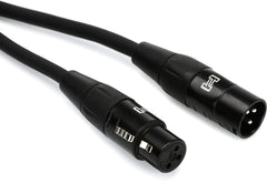 A pair of black and white cables with a black plug, coiled together on a neutral background.