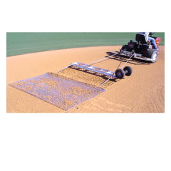 A baseball field with a metal catcher in the foreground, surrounded by bases and a well-maintained grassy area.