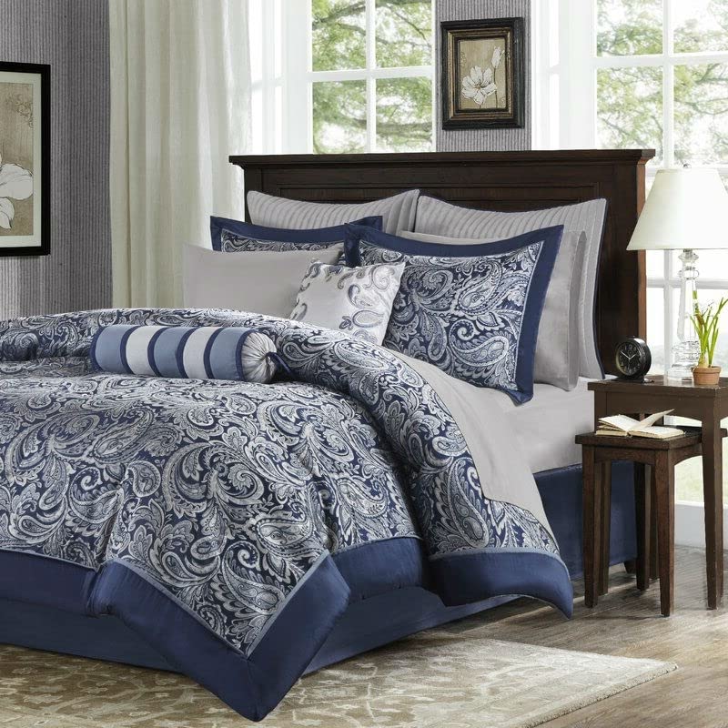 A comforter set in blue and white, adorned with a stylish blue paisley design.