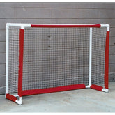 A hockey goal with a vibrant red and white net, set against the backdrop of an ice rink.