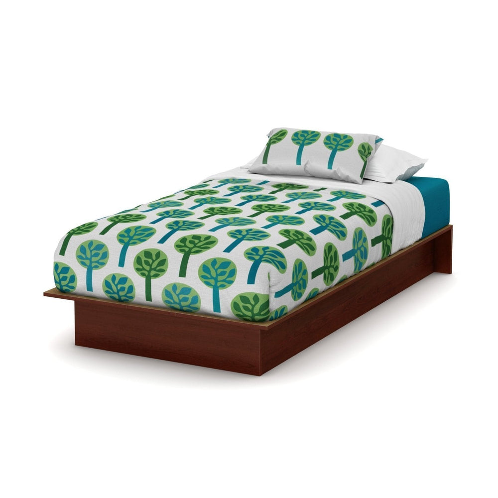 A bed adorned with a vibrant green and blue tree pattern, adding a fresh, natural touch to the room.