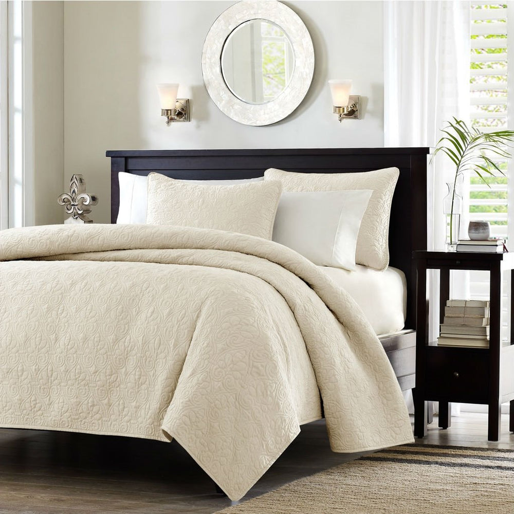 A stylish white bed with a black headboard and a white comforter, offering a clean and modern look in the bedroom.