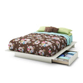 A bed with a floral bedspread and a storage drawer underneath, showcasing a cozy and organized bedroom setting.