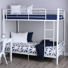 A white bunk bed featuring blue and white pillows, designed for a stylish and comfortable bedroom environment.