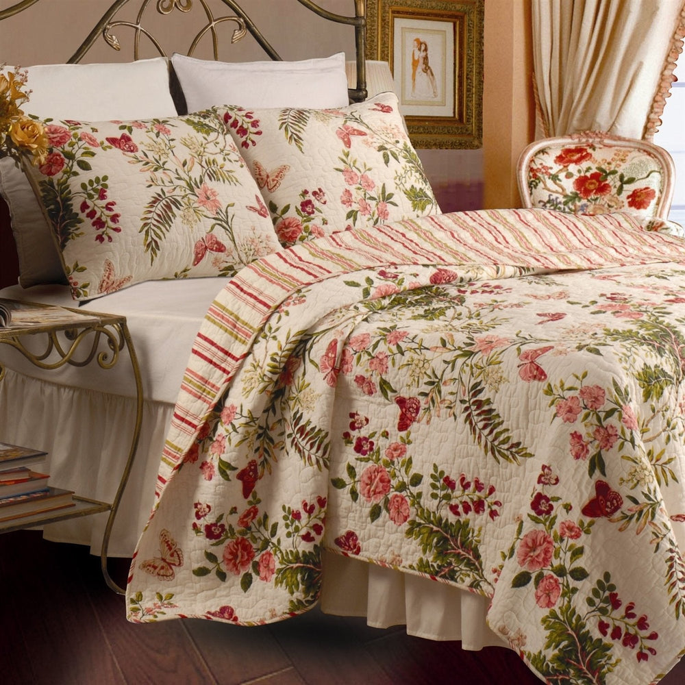 A bed adorned with a vibrant floral quilt and decorative pillows, showcasing a warm and welcoming bedroom setting.