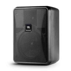 A pair of JBL E10 active speakers positioned on a desk, highlighting their compact size and stylish appearance.