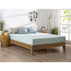 A wooden-framed bed adorned with a vibrant blue sheet covering the mattress.