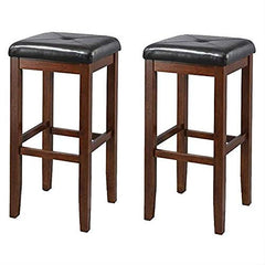  A pair of wooden bar stools with stylish black leather seats, arranged next to each other.