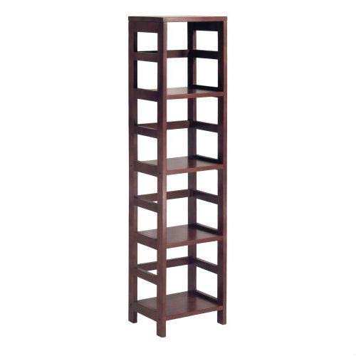 A tall bookshelf with four shelves, filled with various books and decorative items.