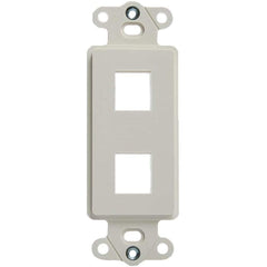 A white wall plate showing four circular openings, typically used for electrical connections.