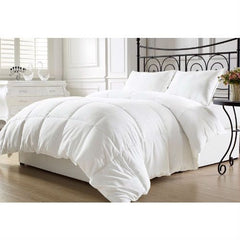 A white comforter on a black iron bed frame, showcasing a modern and elegant bedroom design.