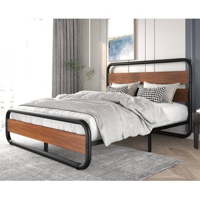 A modern bed with a sleek metal frame and an elegant wooden headboard.