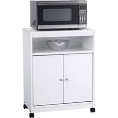 A white cabinet holds a microwave, with a bowl placed on top, showcasing a simple kitchen arrangement.