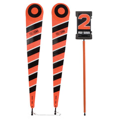 Two orange and black poles displaying a sign, set against a neutral background.