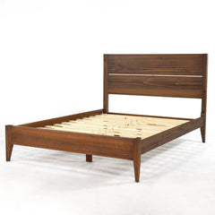  A wooden bed frame with slats and a headboard, emphasizing a classic and functional bedroom style.