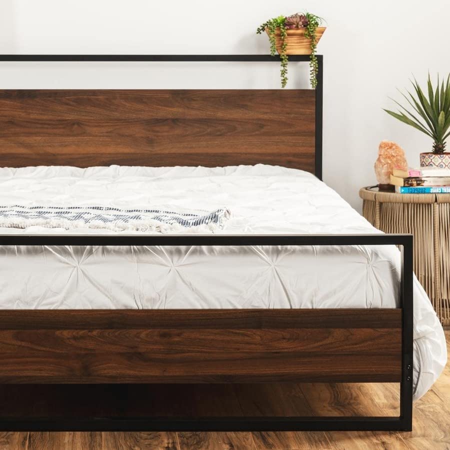 A stylish bed with a metal frame and a warm wood headboard design.