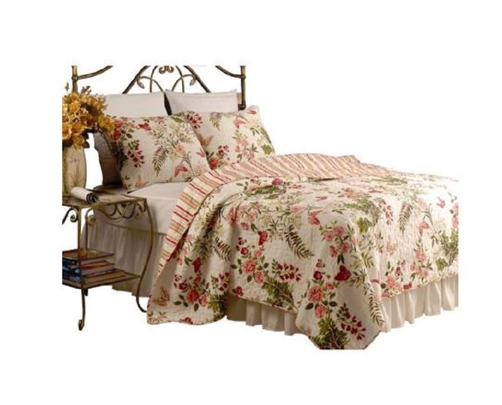 A cozy bed adorned with a vibrant floral comforter and decorative pillows.