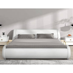  A modern white bed with a sleek grey headboard and footboard, creating a stylish focal point in the room.
