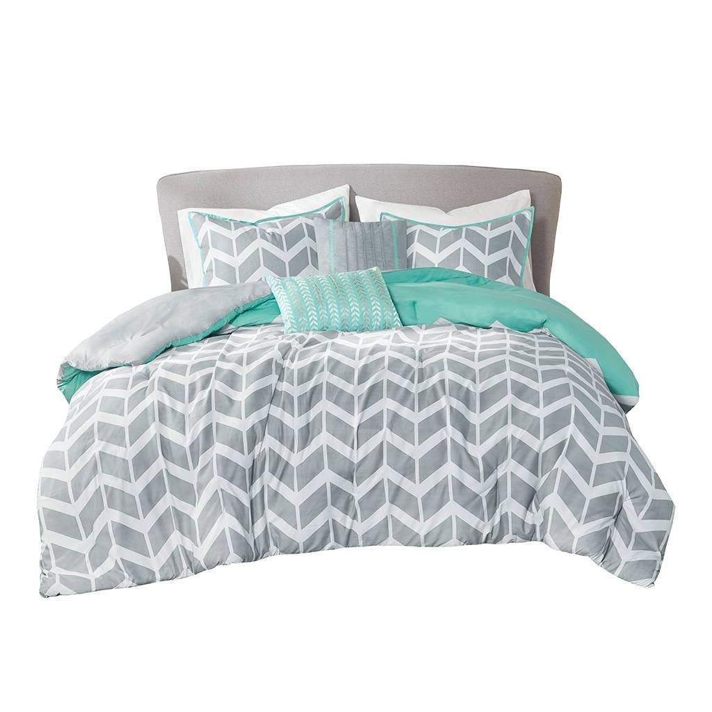 A gray and turquoise comforter set on a white bed, offering a fresh and contemporary look to the bedroom decor.