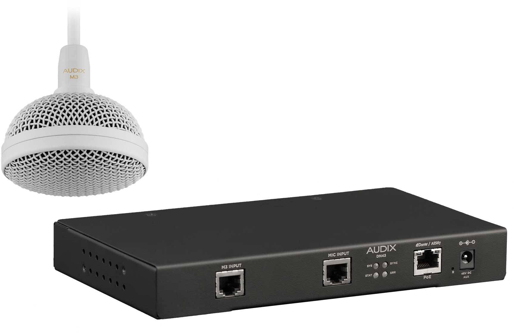 A microphone sits next to a computer on a white background, highlighting a modern workspace setup.