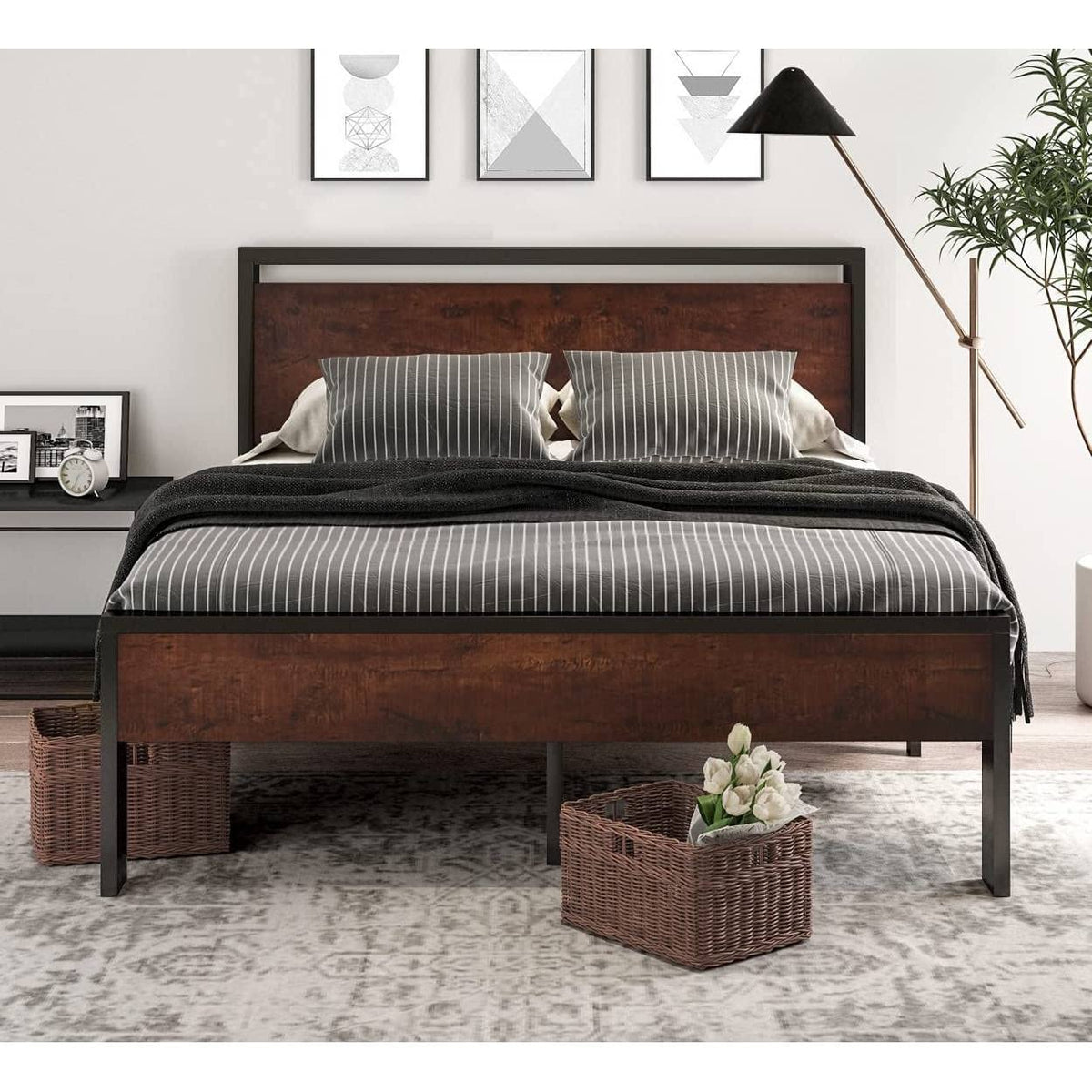  A bed showcasing a sturdy wooden frame complemented by a chic black headboard, ideal for a sophisticated sleeping space.
