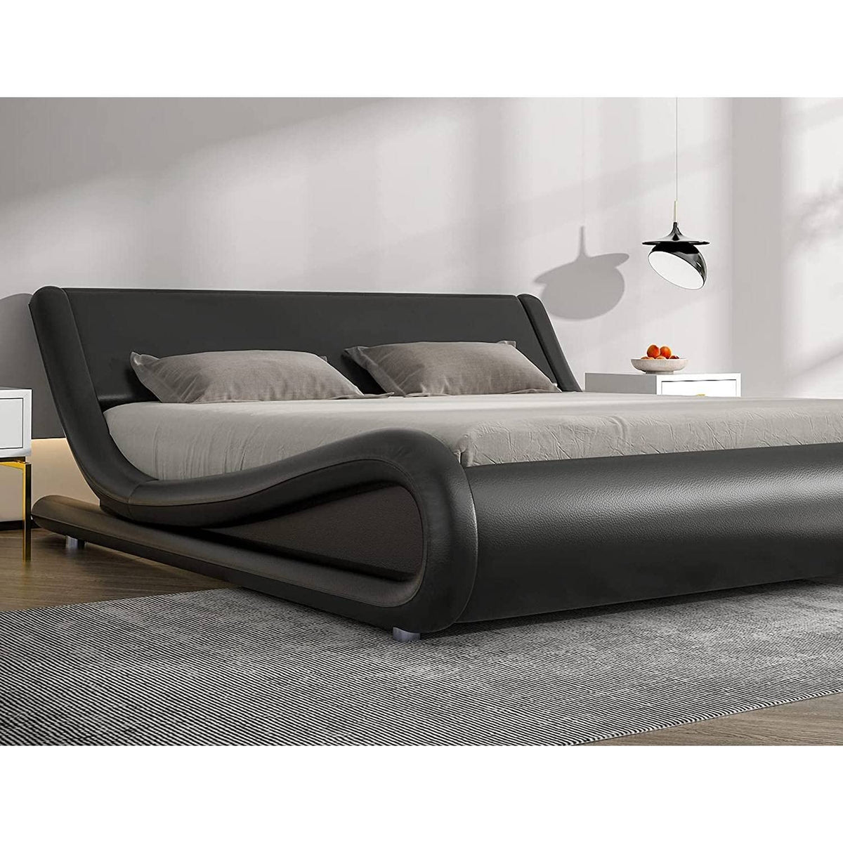  A stylish modern bed adorned with black leather furniture, emphasizing a sophisticated and elegant bedroom look.