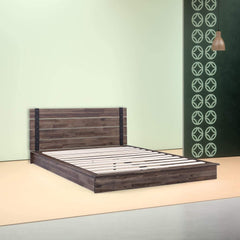 A bed featuring wooden slats, set against a calming green wall, contributing to a serene bedroom environment.