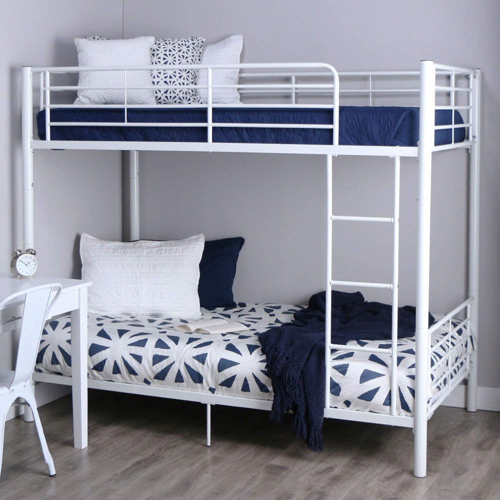 A white bunk bed featuring blue and white pillows, designed for a stylish and comfortable bedroom environment.