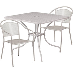 A white outdoor table accompanied by two matching chairs set against a natural background.