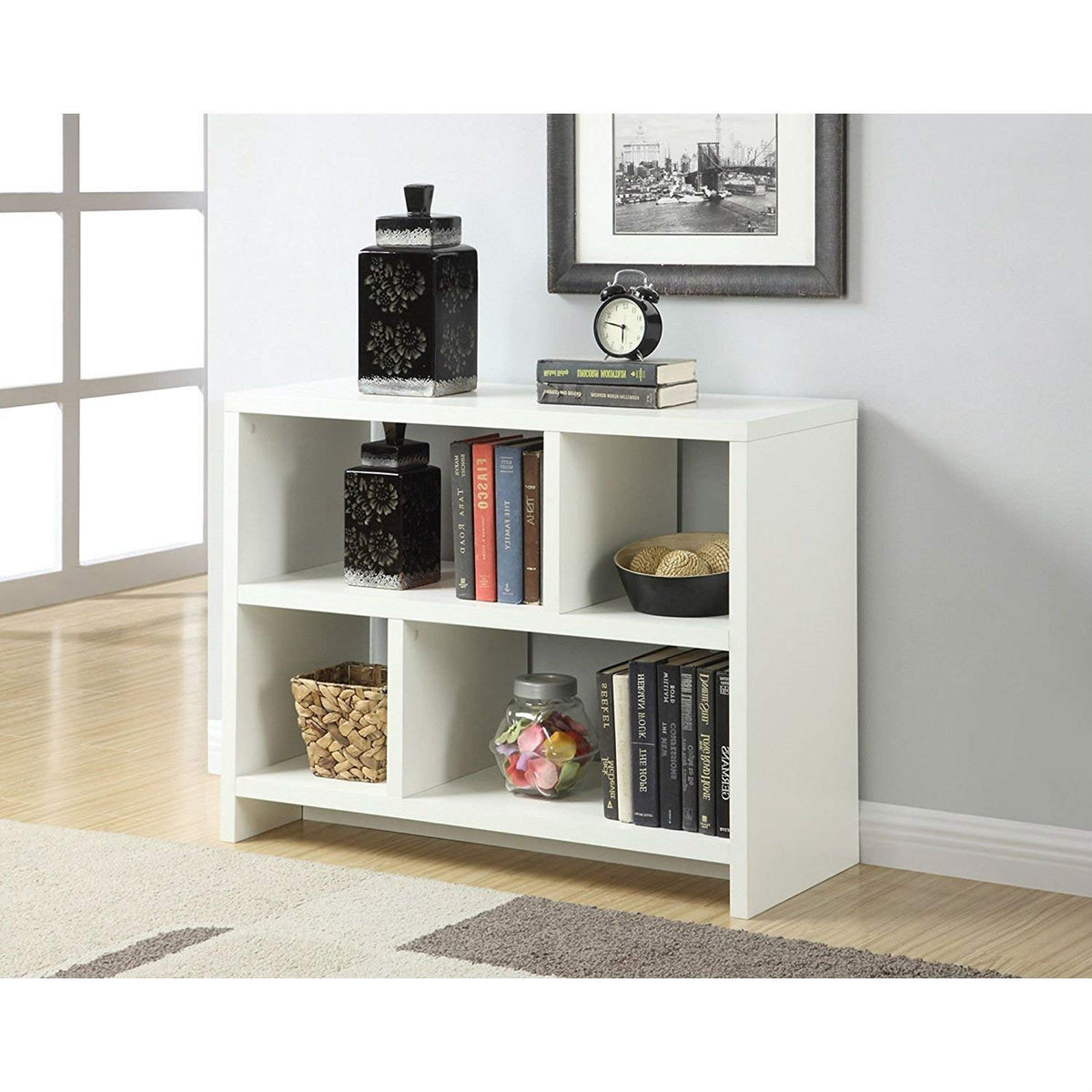 A white bookcase displaying an assortment of books and decorative objects, creating a neat and inviting atmosphere.