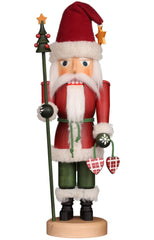 A nutcracker Santa figure holding a stick in one hand and a bag in the other, dressed in traditional festive attire.