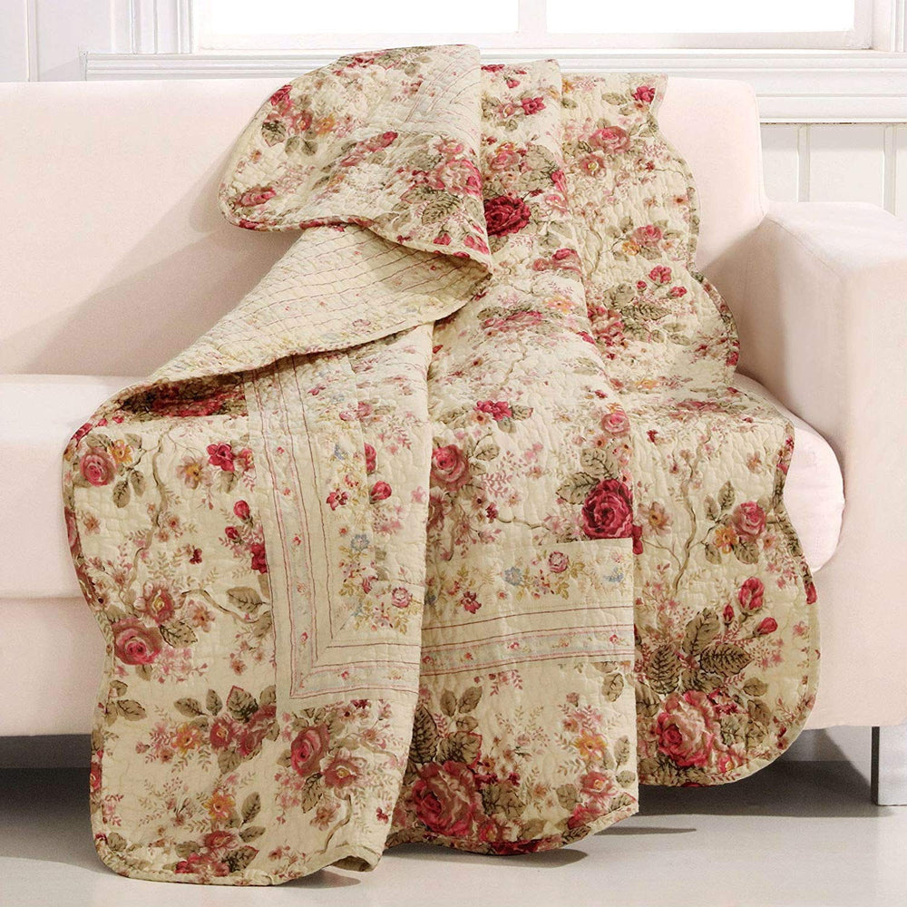 A vibrant floral quilt covers a couch, adding warmth and color to the inviting living space.