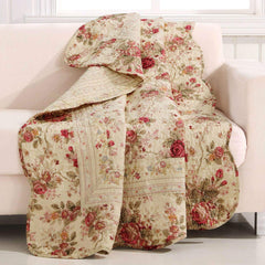 A vibrant floral quilt covers a couch, adding warmth and color to the inviting living space.