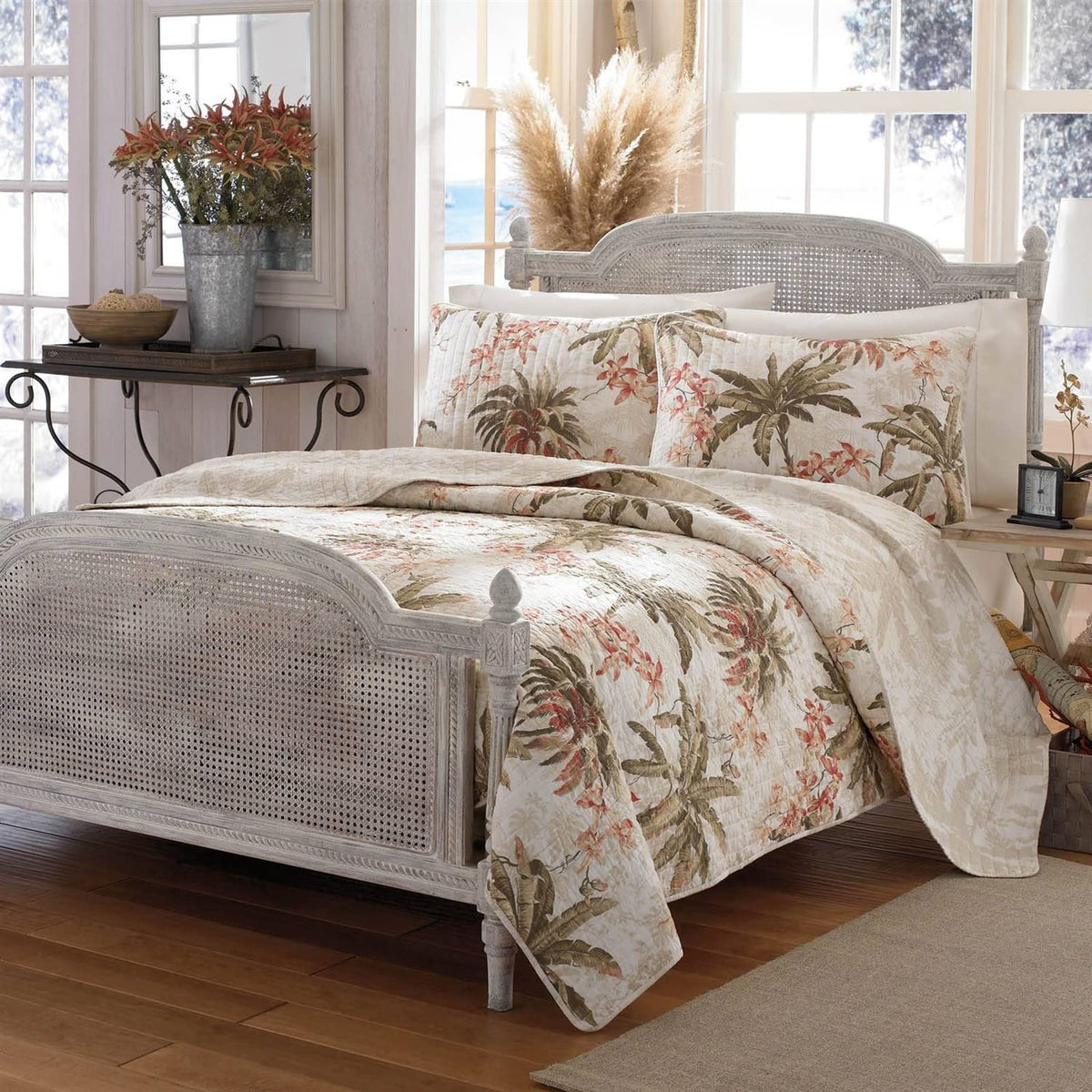 A cozy bed adorned with a white bedspread and a white headboard, creating a serene atmosphere.