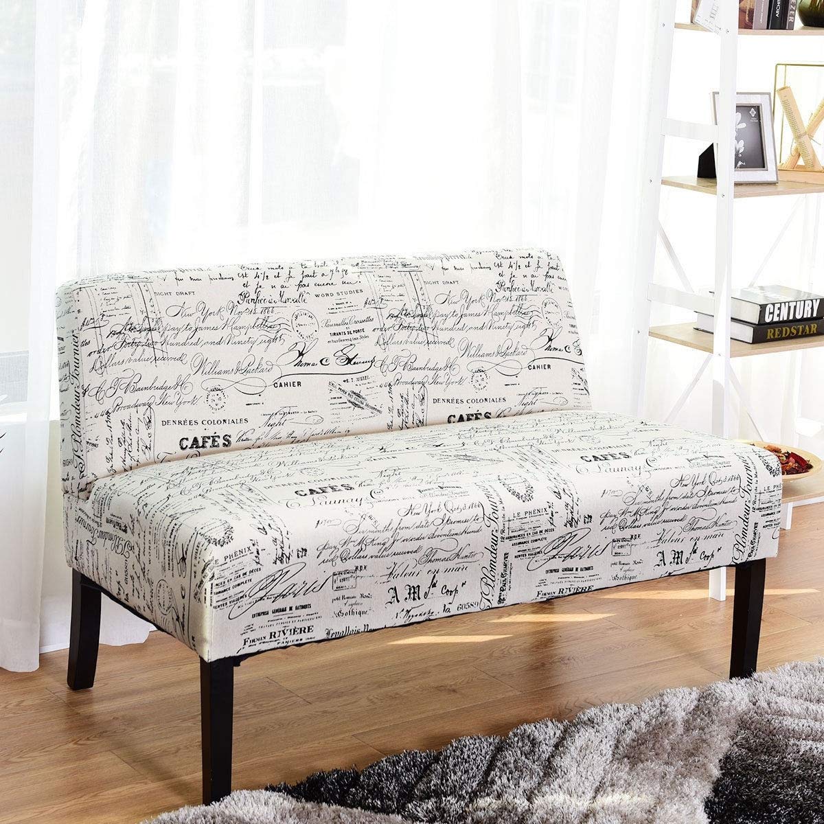 A stylish white couch with a sleek black frame and a plush white fabric covering, perfect for contemporary interiors.