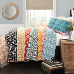 A vibrant quilt displayed on a bed, accompanied by matching pillows and a colorful bedspread.