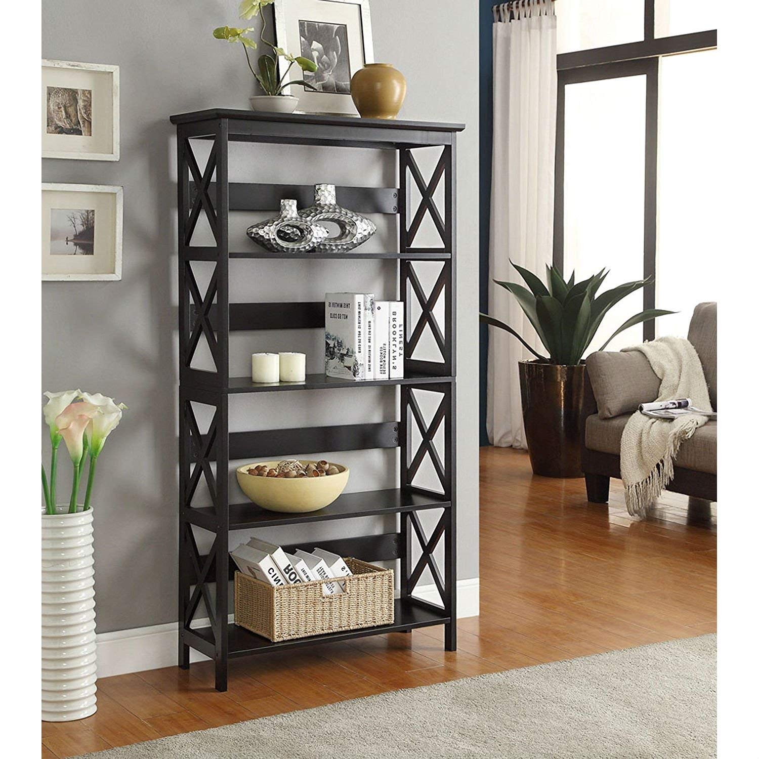 A sleek black bookcase featuring various baskets and vases, showcasing an organized and stylish storage solution.