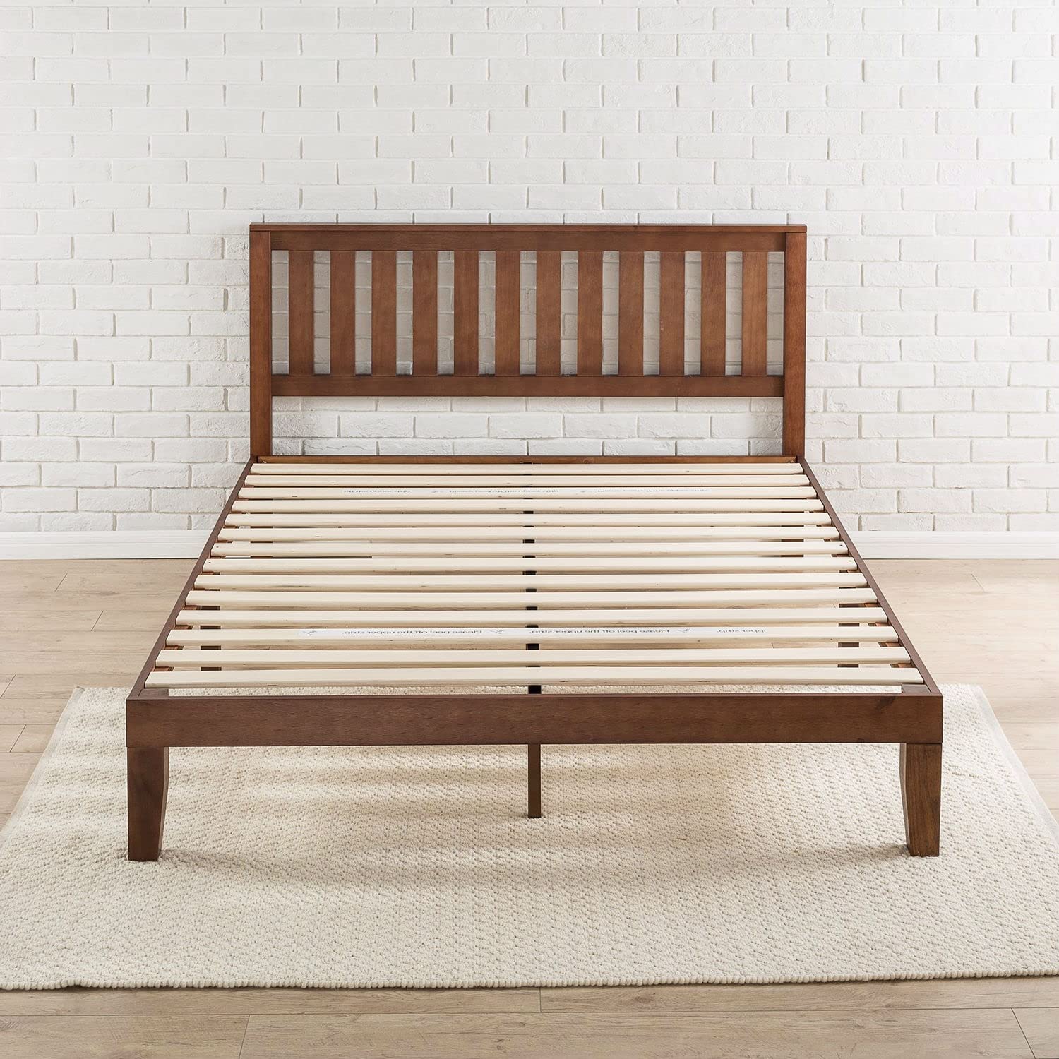 A wooden bed frame featuring slats and a matching headboard, showcasing a natural finish and sturdy design.