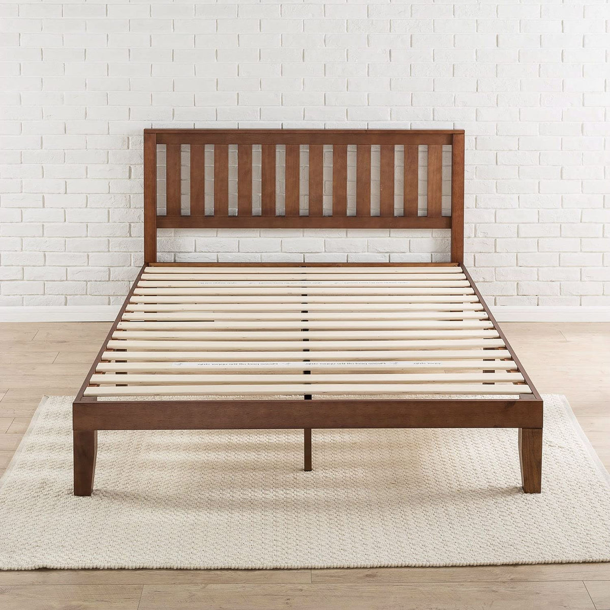 A wooden bed frame featuring slats and a matching headboard, showcasing a natural finish and sturdy design.